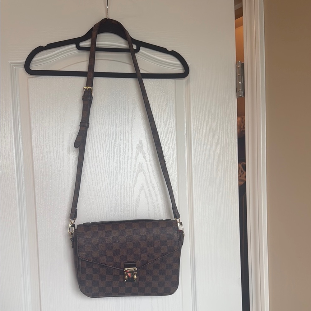Brown checkered purse with gold details
